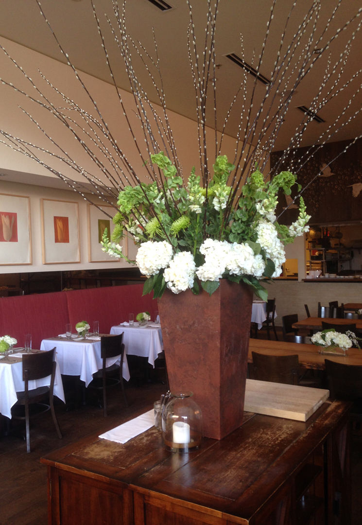 tall arrangement of white flowers and pussywillow